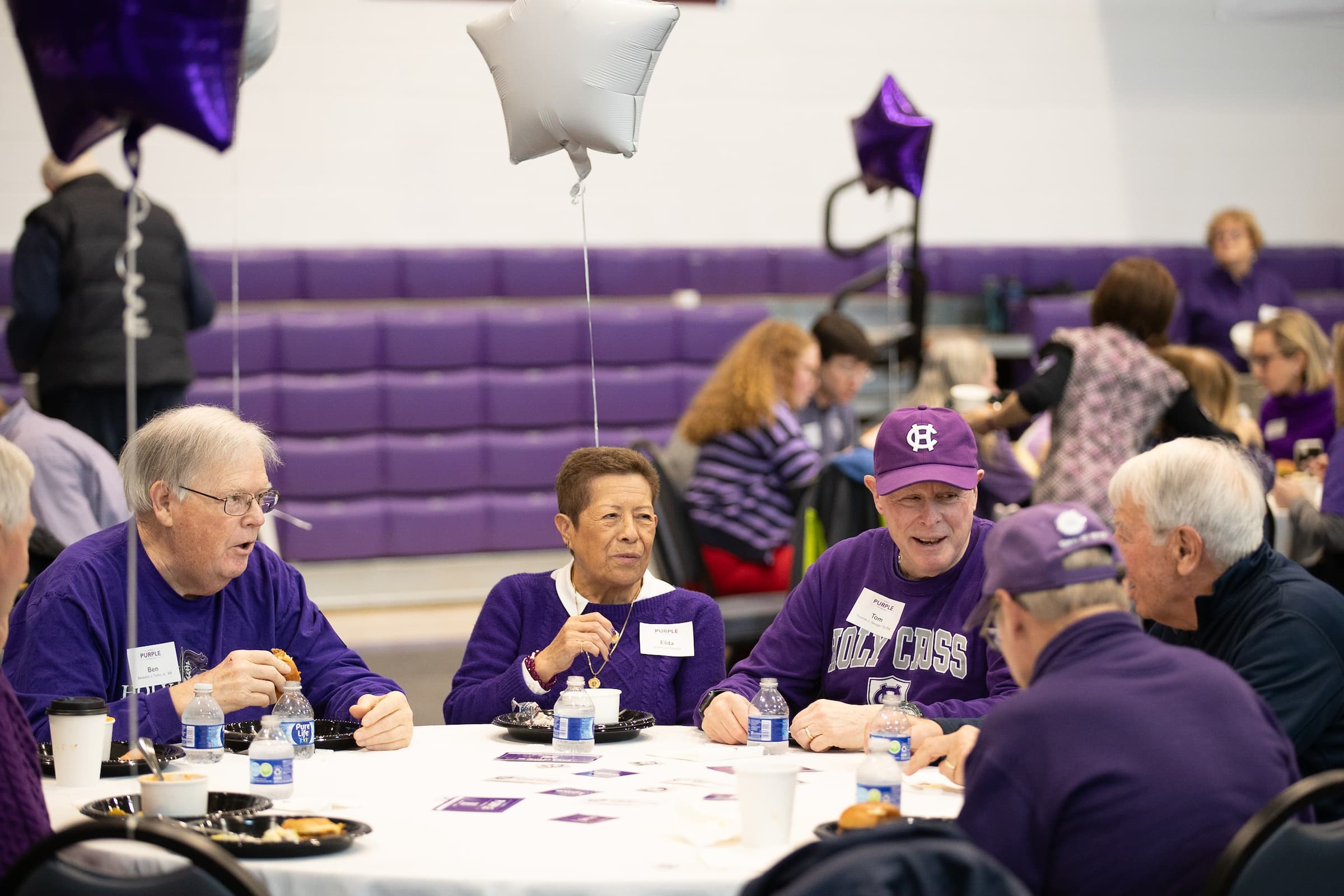 a group of alumni sitting at a table together
